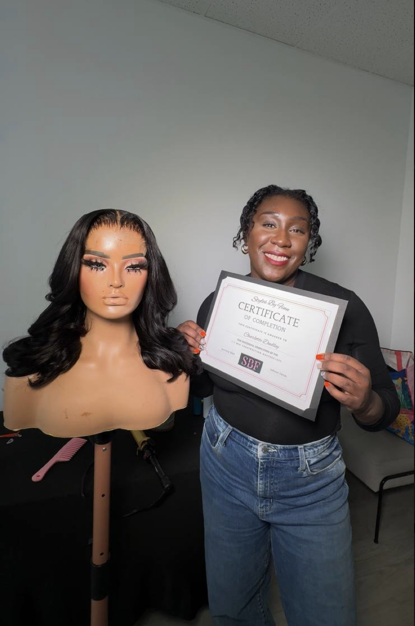 Graduate holding SBF certificate next to finished wavy wig